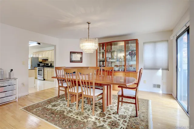 a dining room with furniture window and wooden floor