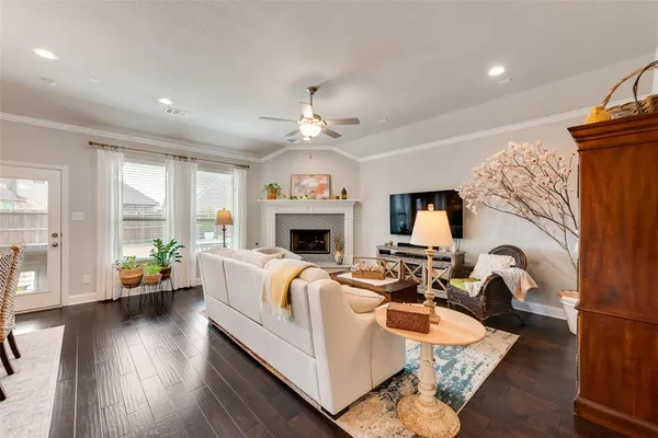 a living room with furniture fireplace and flat screen tv