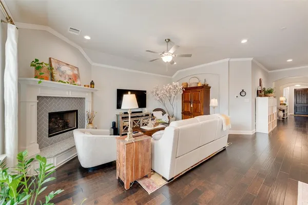 a living room with furniture fireplace and flat screen tv