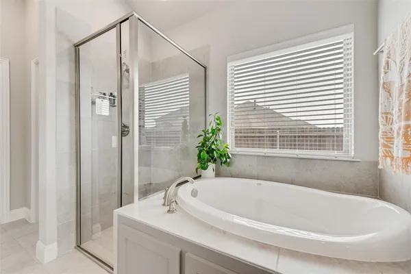 a white bath tub sitting next to a white sink