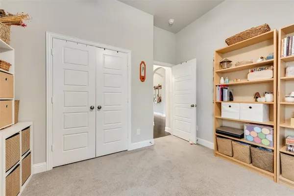 a view of walk in closet with empty racks