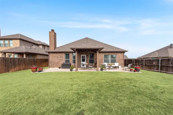 a front view of a house with swimming pool and porch with furniture