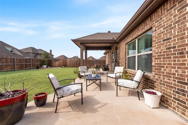 a view of a patio with couches chairs and a yard