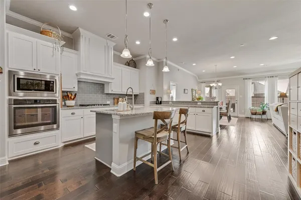 a kitchen with a sink stainless steel appliances and cabinets