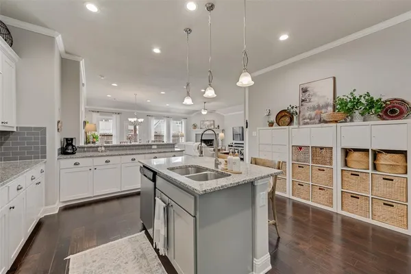 a kitchen with a sink stove and cabinets
