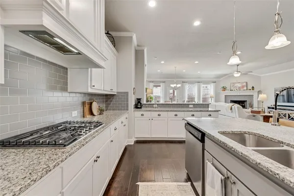 a kitchen with a sink stove top oven and cabinets