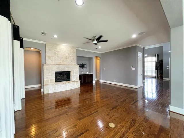 a view of a hallway with dining room and wooden floor
