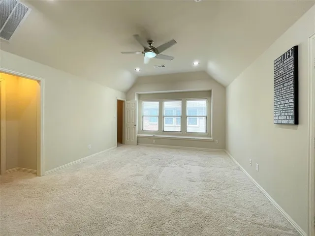 a view of a hallway to a room with windows