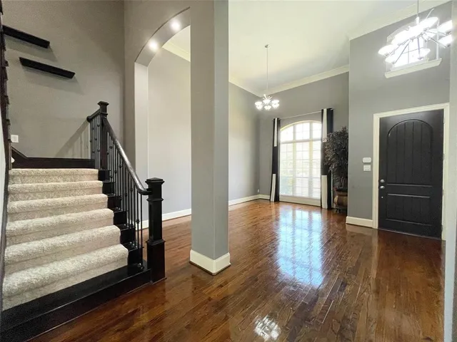 a view of an entryway with wooden floor