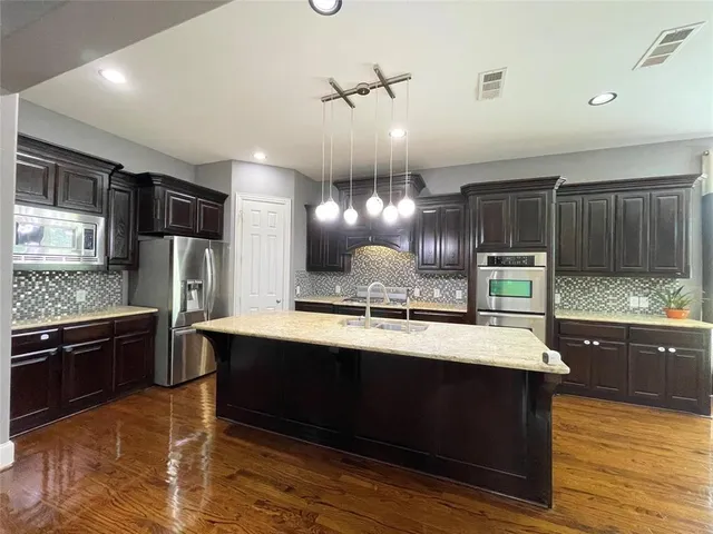 a kitchen with counter top space cabinets and stainless steel appliances