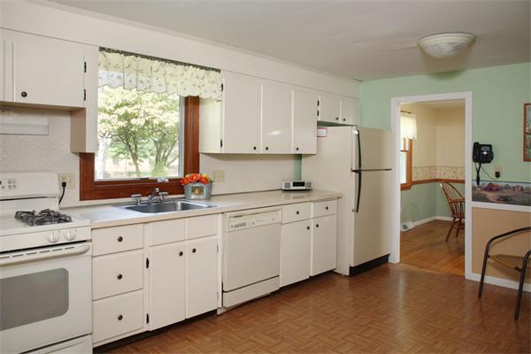 85 Oxbow Road Wayland, MA 01778 - Photo 5 of 8 a kitchen with white cabinets and white appliances