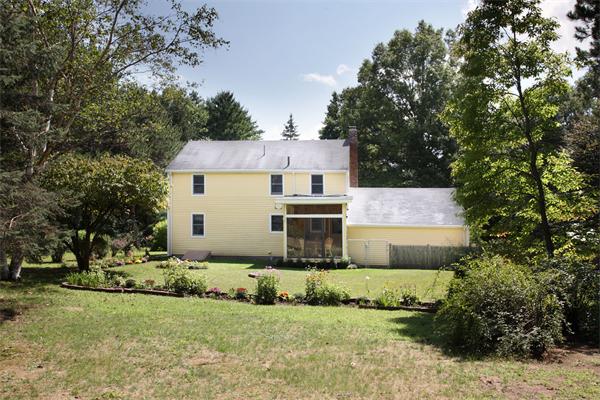 85 Oxbow Road Wayland, MA 01778 - Photo 6 of 8 a front view of house with yard and trees in the background