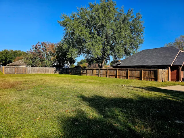 a view of swimming pool and tree in the background