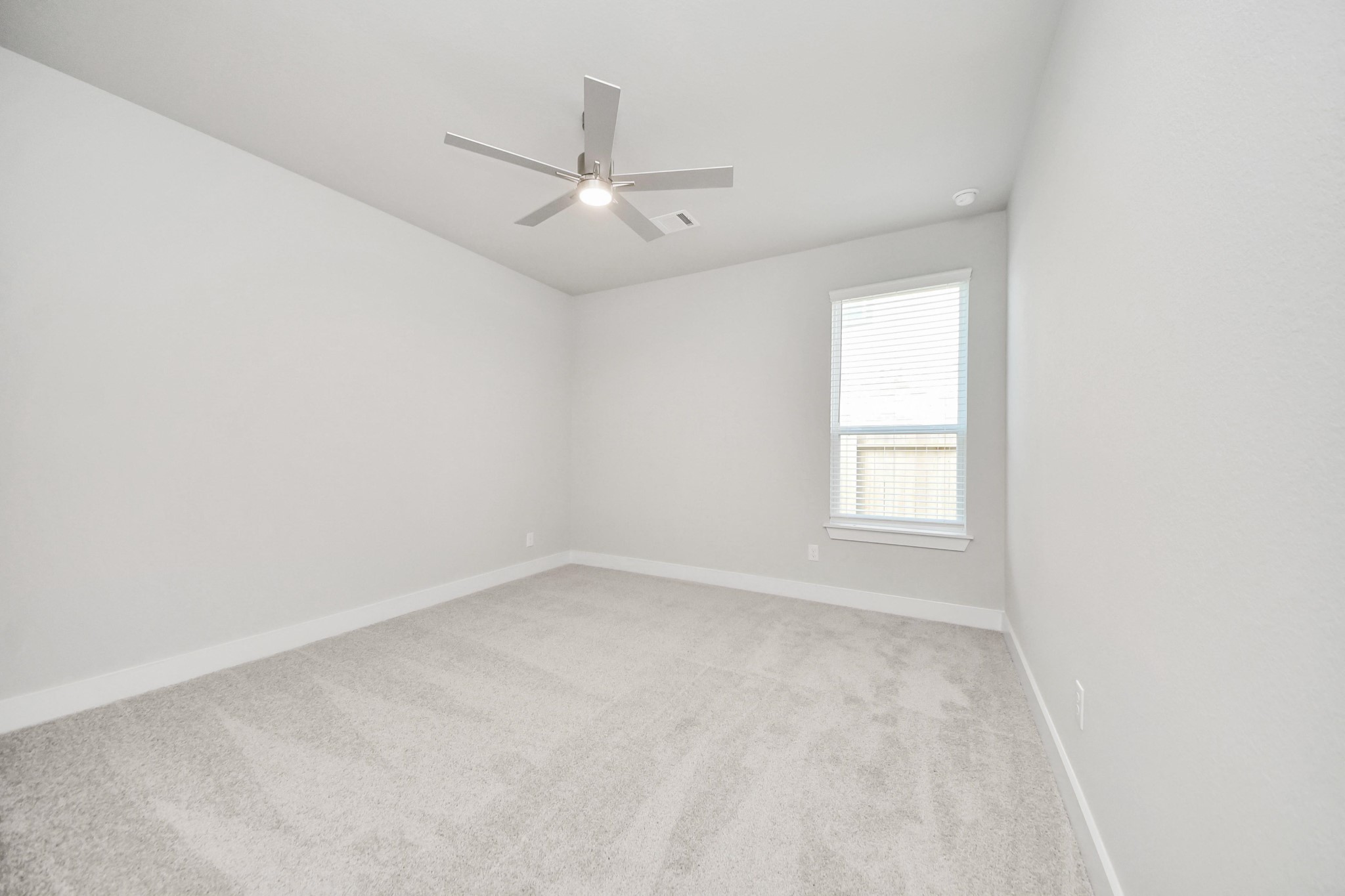 3042 Native Spg Drive Spring, TX 77373 - Photo 11 of 32 Generously sized secondary bedrooms featuring spacious closets, soft and inviting carpeting underfoot, large windows allowing plenty of natural light, and the added touch of privacy blinds for your personal retreat. Sample photo of completed home with similar floor plan. Actual colors and selections may vary.