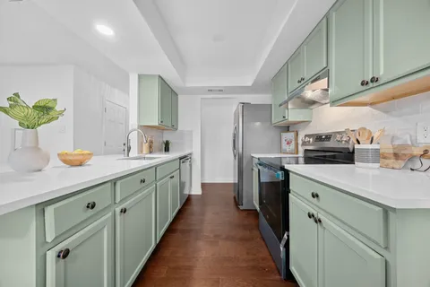 a kitchen with sink and cabinets