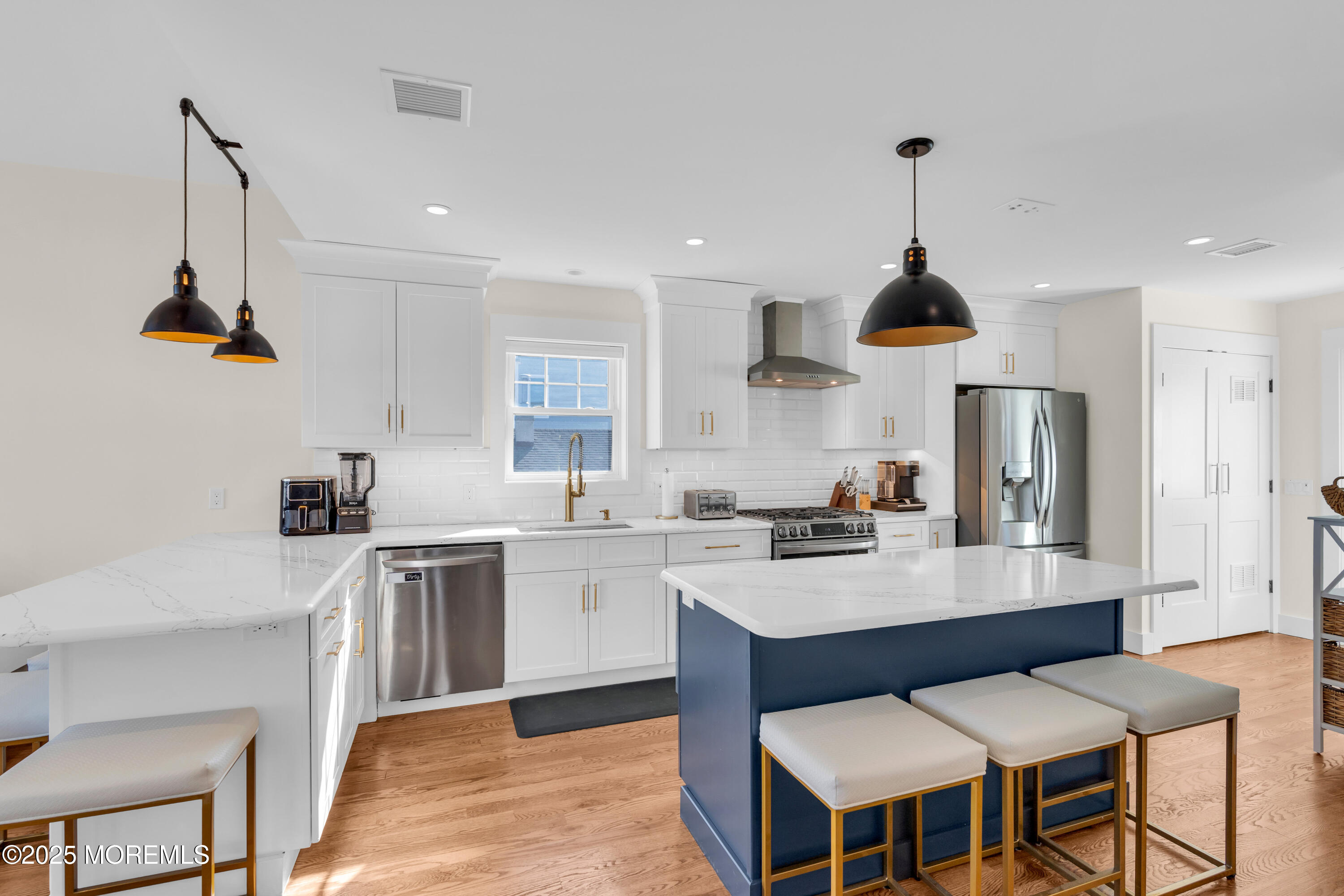 455 East Main Street Manasquan, NJ 08736 - Photo 21 of 47 a kitchen with stainless steel appliances kitchen island granite countertop a sink a stove a refrigerator and island with wooden floor