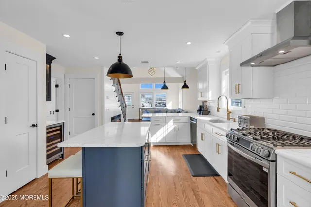 a kitchen that has a table chairs and a refrigerator