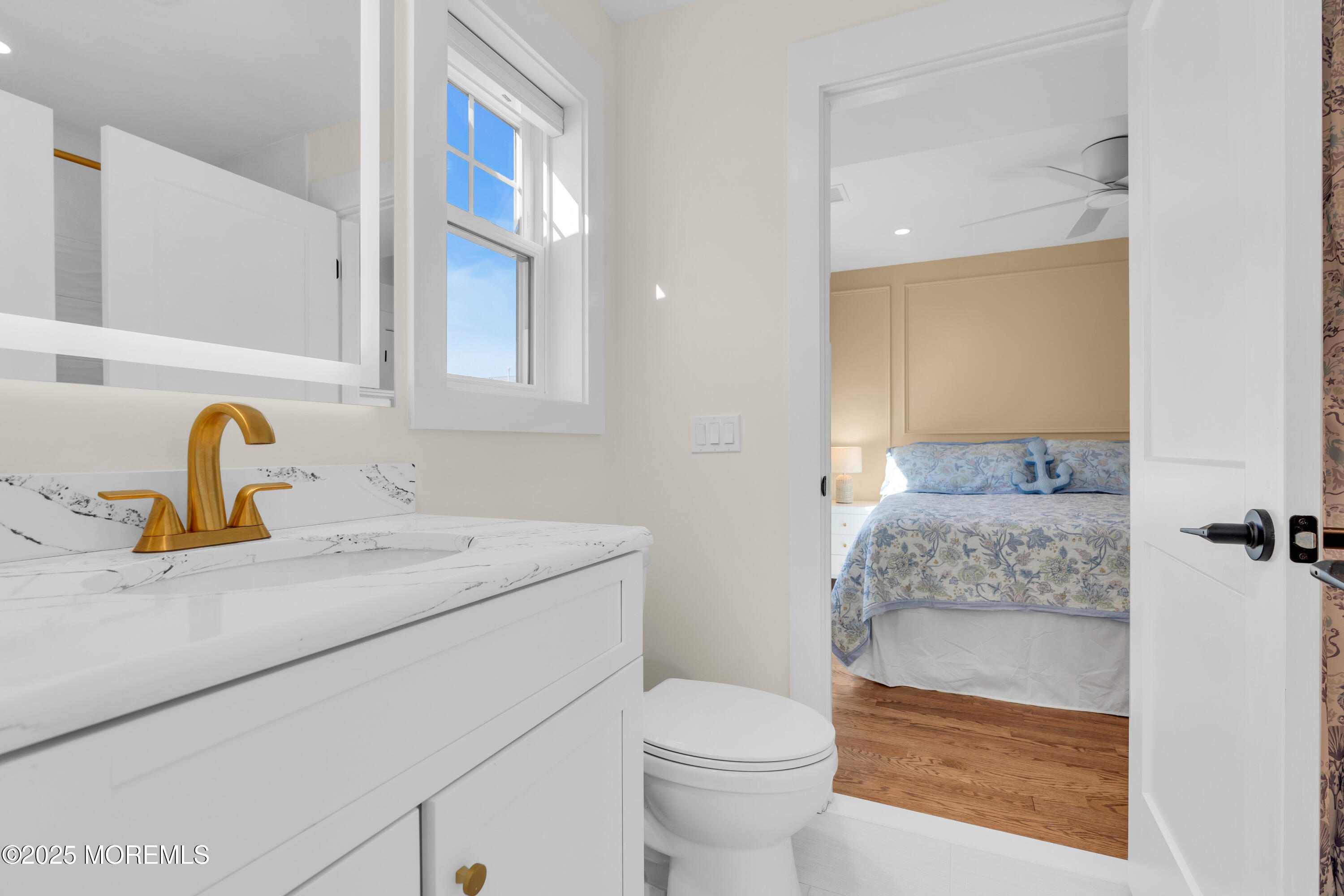 455 East Main Street Manasquan, NJ 08736 - Photo 28 of 47 a bathroom with a granite countertop sink and a mirror