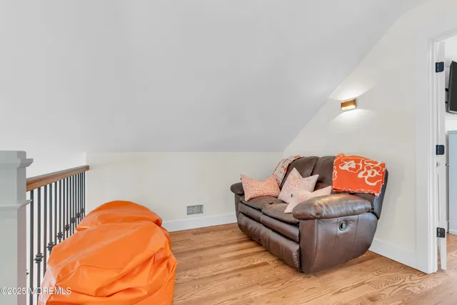 a view of hallway with wooden floor