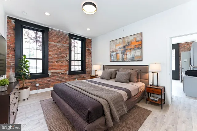 a spacious bedroom with a large bed and a couch