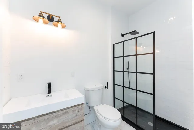a bathroom with a toilet a sink and shower