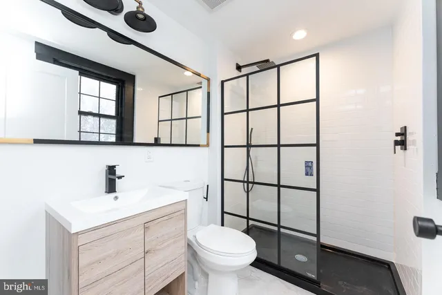 a bathroom with a toilet sink and a shower