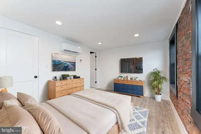 a bedroom with a bed and a flat screen tv