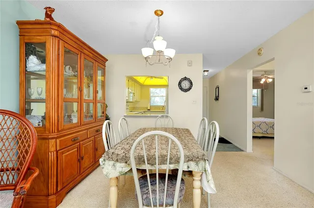 a view of a dining room with furniture chandelier and a chandelier