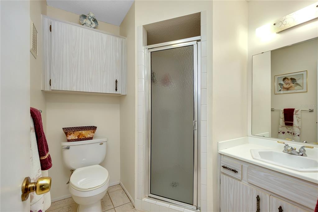 2280 Stickney Point Road, Unit 432 Sarasota, FL 34231 - Photo 20 of 35 a bathroom with a toilet sink and a mirror