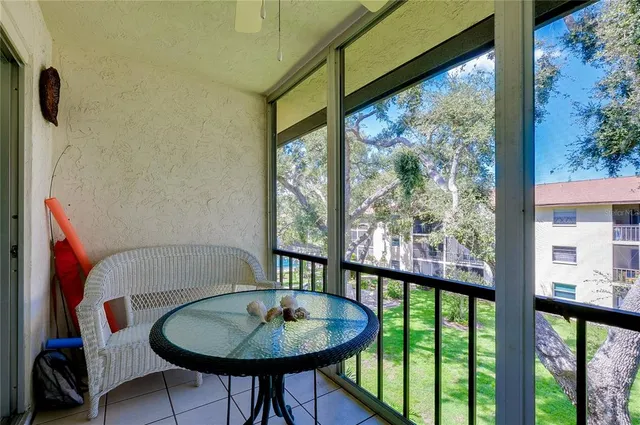 a view of a porch with furniture and wooden floor