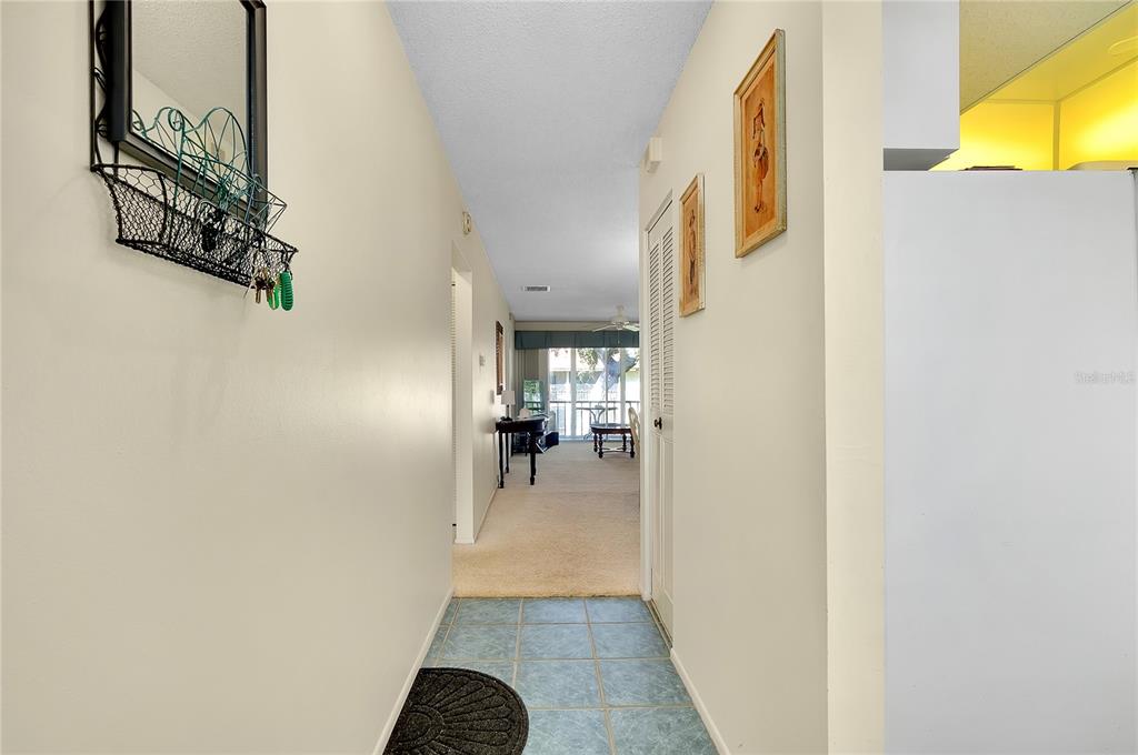 2280 Stickney Point Road, Unit 432 Sarasota, FL 34231 - Photo 3 of 35 a view of entryway and hall with wooden floor