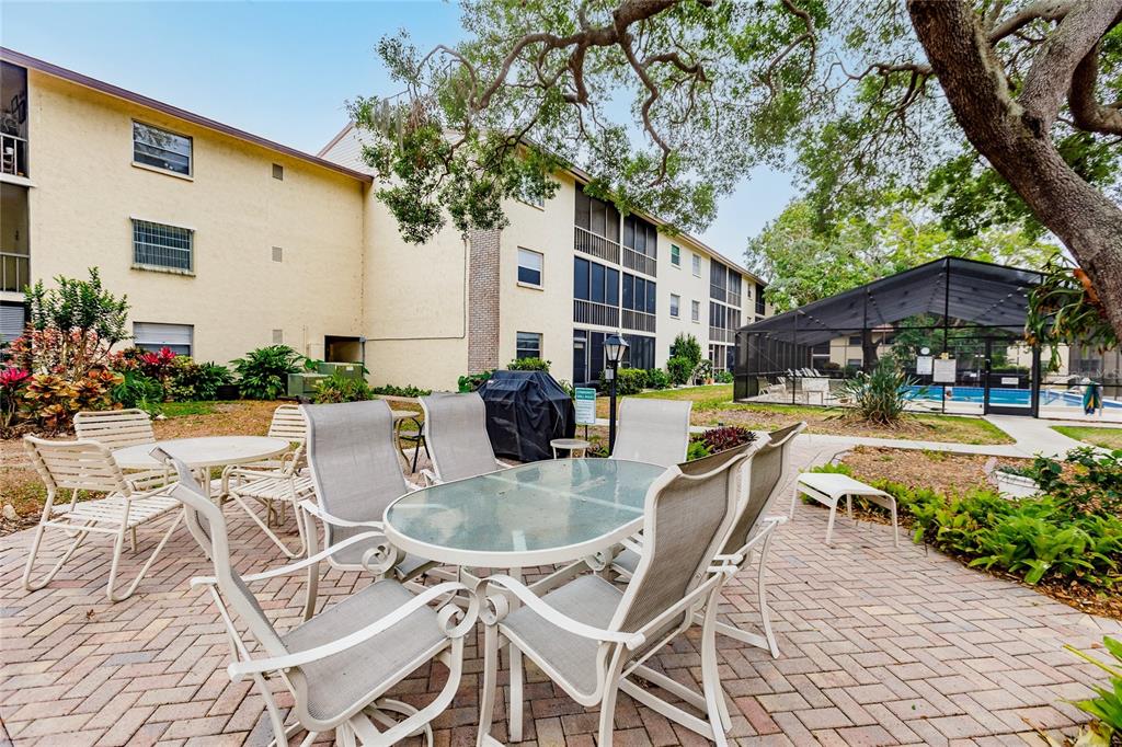 2280 Stickney Point Road, Unit 432 Sarasota, FL 34231 - Photo 32 of 35 a swimming pool with outdoor seating and yard
