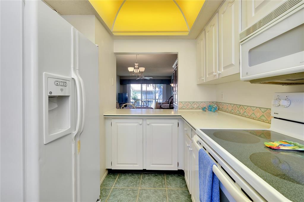 2280 Stickney Point Road, Unit 432 Sarasota, FL 34231 - Photo 7 of 35 a kitchen with a sink and a refrigerator