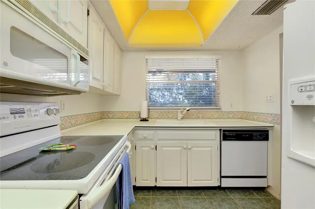 a kitchen with a sink stove and cabinets