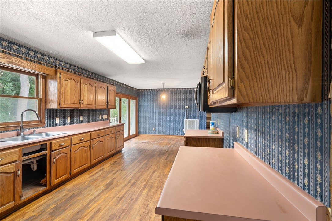 133 Pinetree Lane Easley, SC 29640 - Photo 18 of 28 Rich hardwood flooring pairs with wood cabinetry in this functional space.