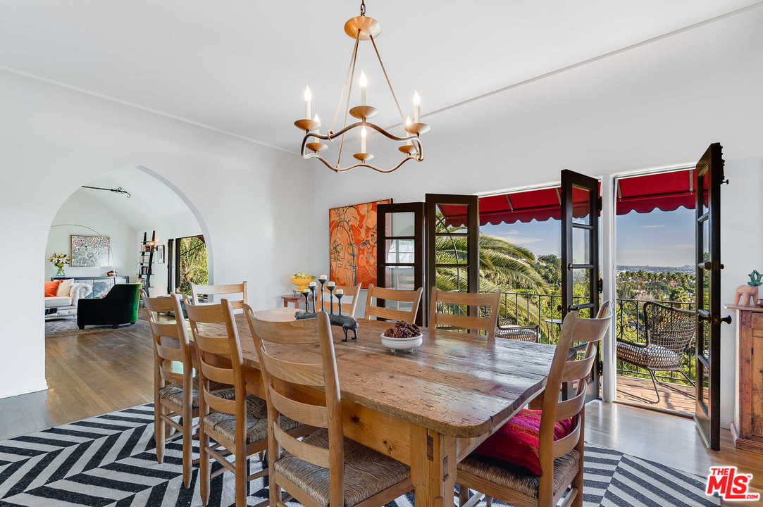 2318 Hollyridge Drive Los Angeles, CA 90068 - Photo 11 of 40 a view of a dining room and livingroom with furniture wooden floor a chandelier
