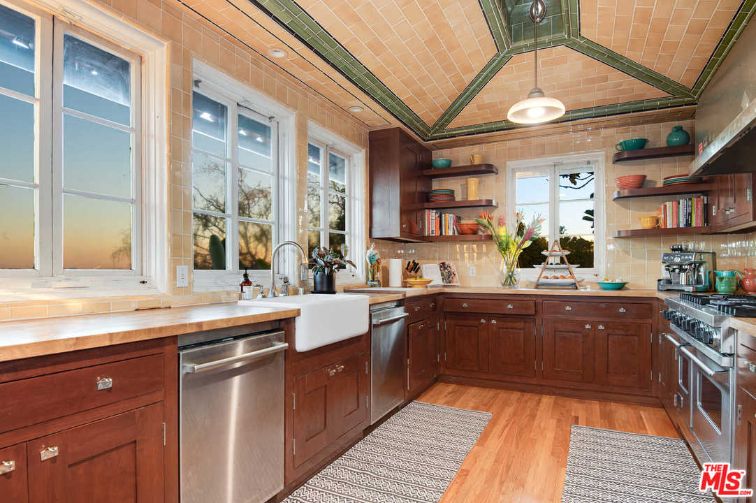 2318 Hollyridge Drive Los Angeles, CA 90068 - Photo 13 of 40 a kitchen with stainless steel appliances granite countertop a sink and wooden cabinets