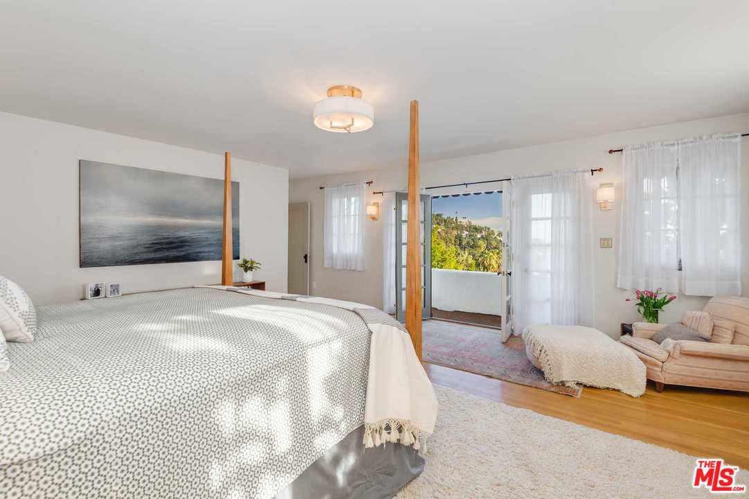 2318 Hollyridge Drive Los Angeles, CA 90068 - Photo 19 of 40 a spacious bedroom with a bed and a couch