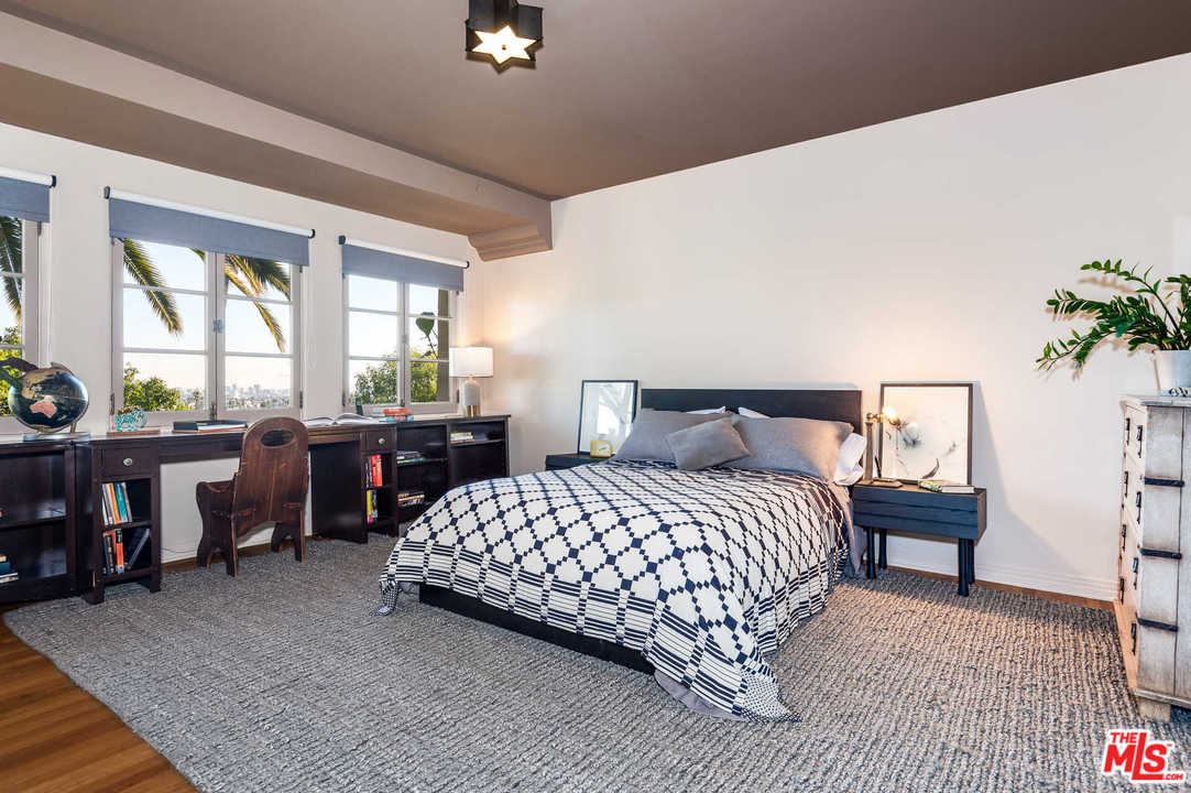 2318 Hollyridge Drive Los Angeles, CA 90068 - Photo 27 of 40 a bedroom with a bed and a table in it