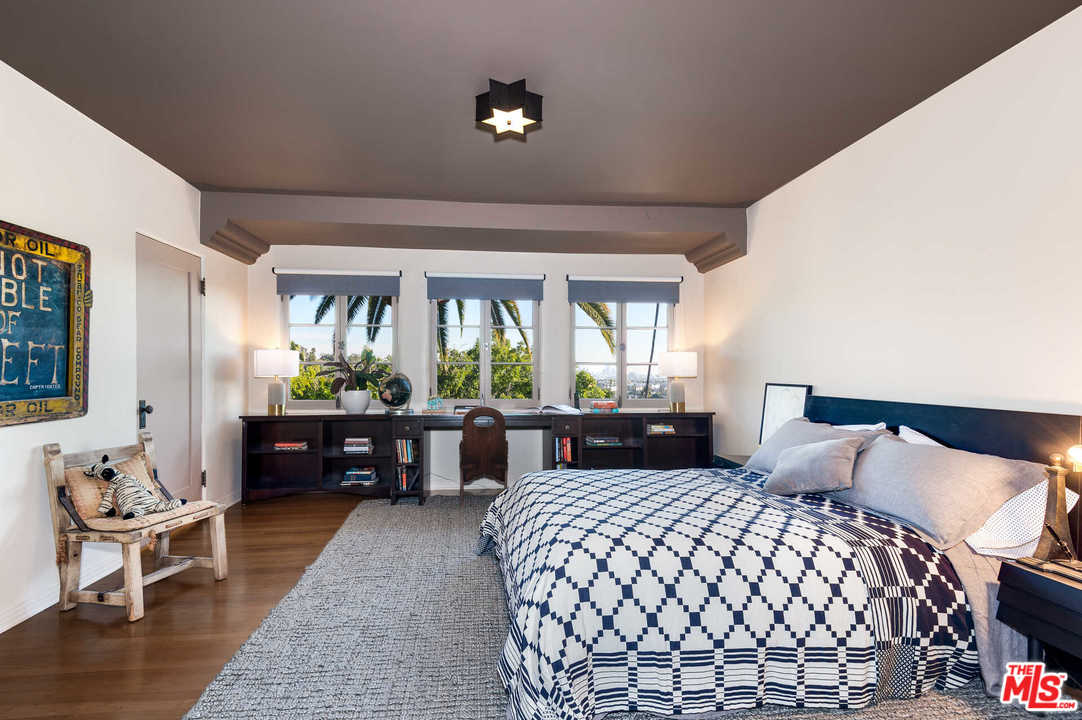 2318 Hollyridge Drive Los Angeles, CA 90068 - Photo 28 of 40 a bedroom with a bed and wooden floor