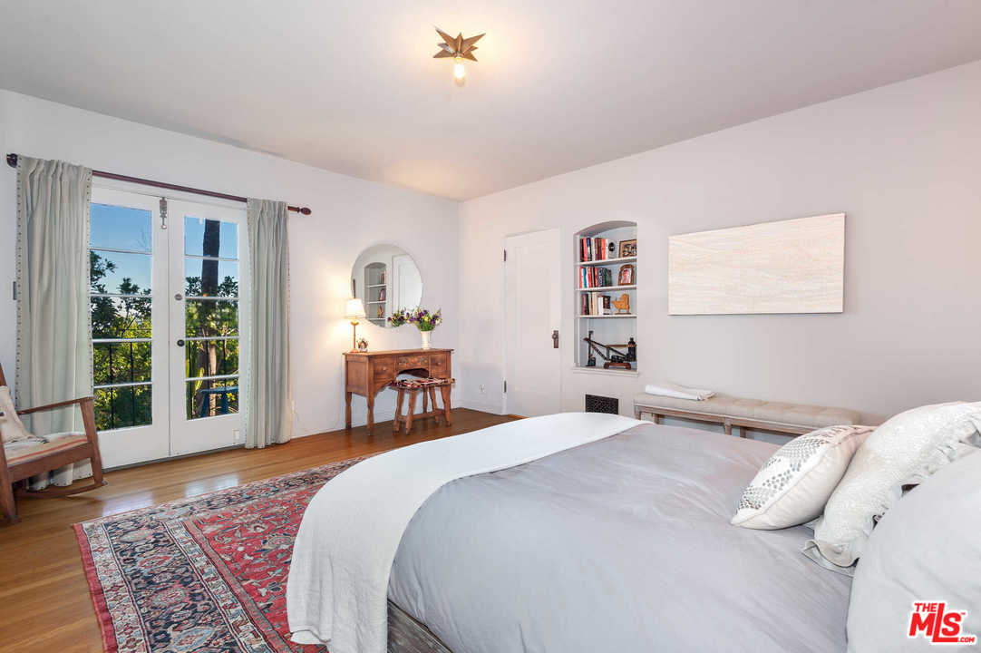 2318 Hollyridge Drive Los Angeles, CA 90068 - Photo 29 of 40 a bedroom with a bed and wooden floor