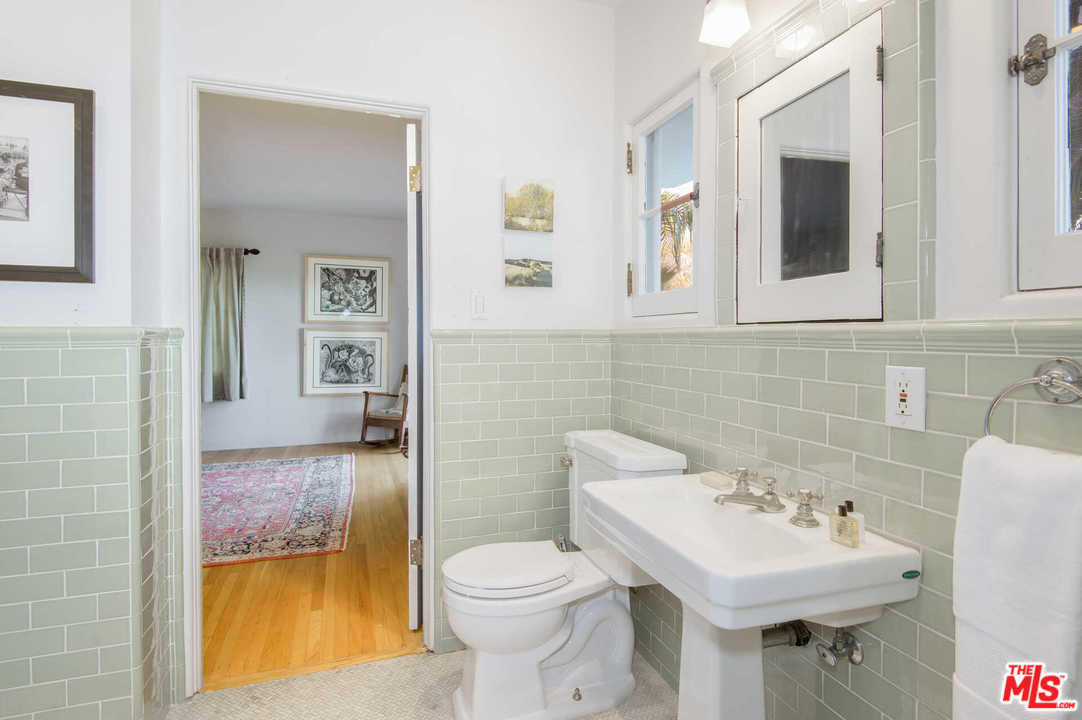 2318 Hollyridge Drive Los Angeles, CA 90068 - Photo 31 of 40 a bathroom with a sink toilet and mirror
