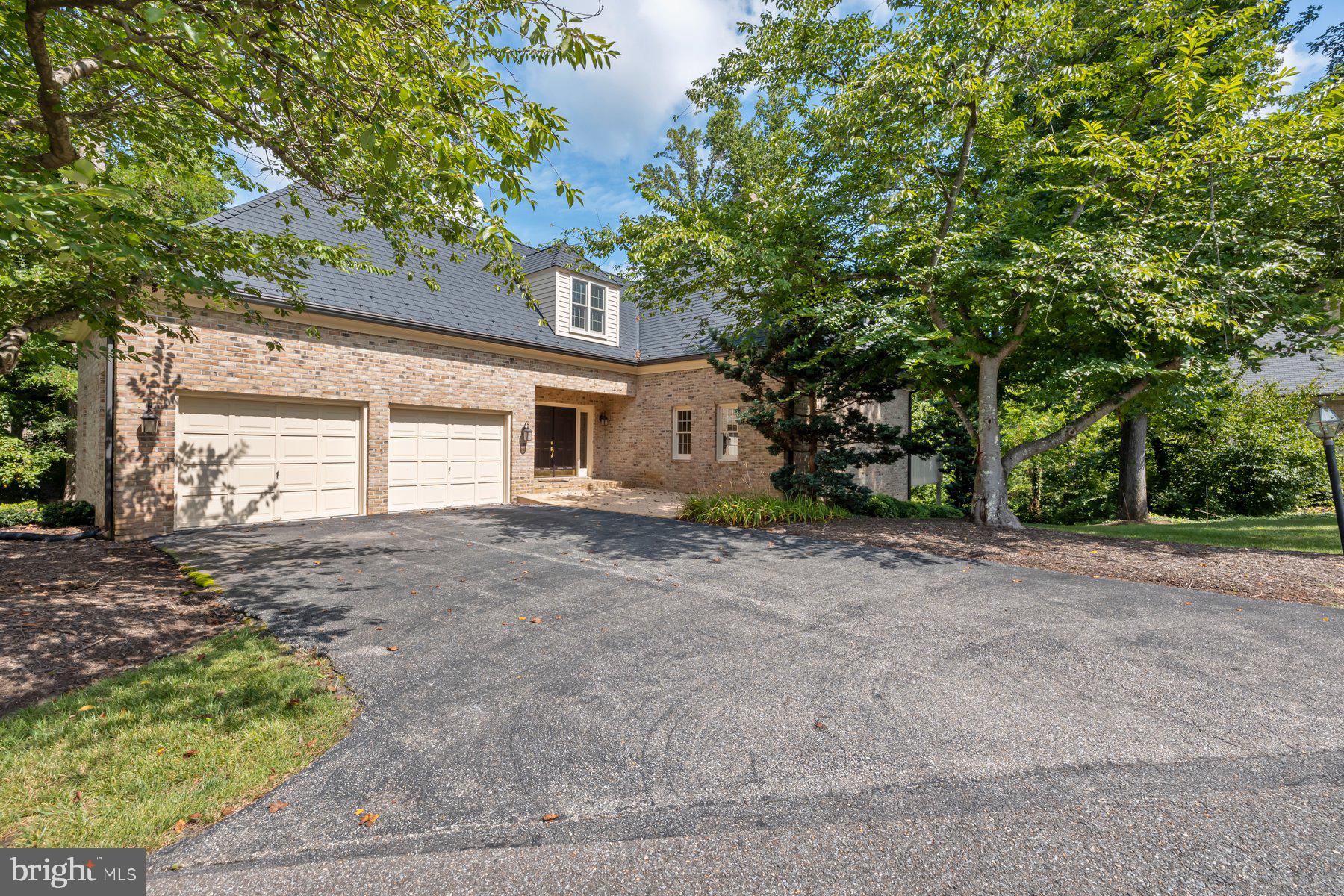 a view of a house with a backyard and a tree