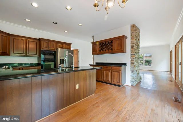 a kitchen with stainless steel appliances granite countertop a sink a stove and a refrigerator