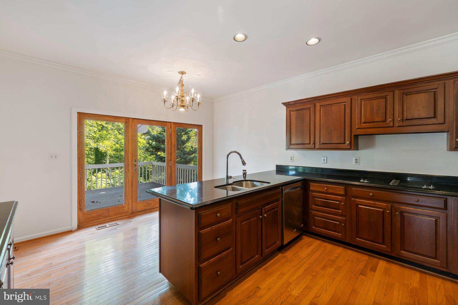 370 South River Landing Road, Unit 370 Edgewater, MD 21037 - Photo 14 of 64 a kitchen with stainless steel appliances granite countertop wooden cabinets a sink and dishwasher with wooden floor