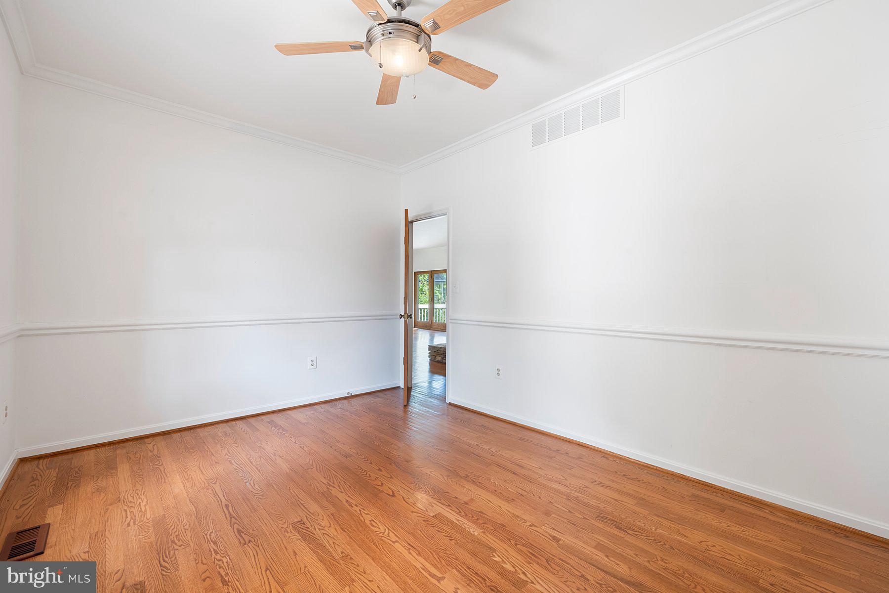 370 South River Landing Road, Unit 370 Edgewater, MD 21037 - Photo 20 of 64 an empty room with wooden floor fan and windows