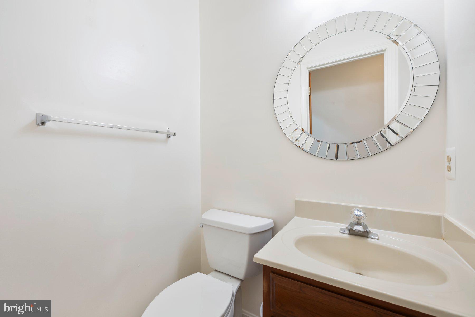 370 South River Landing Road, Unit 370 Edgewater, MD 21037 - Photo 21 of 64 a bathroom with a sink mirror and toilet