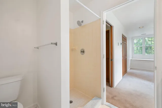 a bathroom with a sink vanity mirror and toilet
