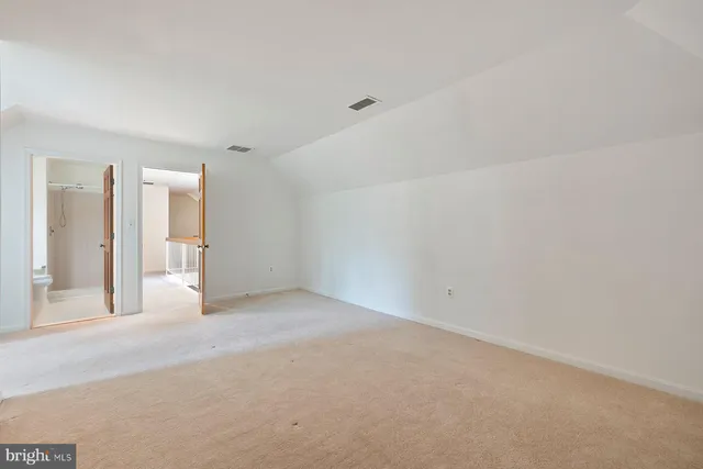 a view of an empty room with a fireplace and a window