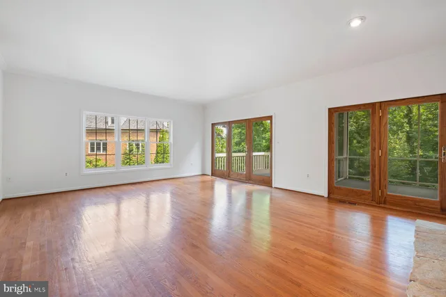 a view of empty room with wooden floor and fireplace